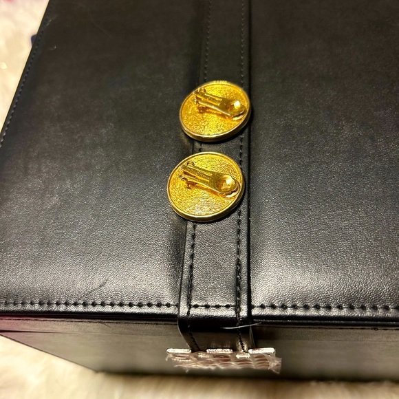 Christian Dior Iconic Monogram Clip Earrings on a Soft Texture Background - Picture 3 of 4